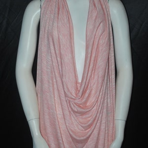 May include: A pink and white striped fabric draped over a mannequin. The fabric is soft and flowing, and it would be perfect for making a dress, skirt, or top.