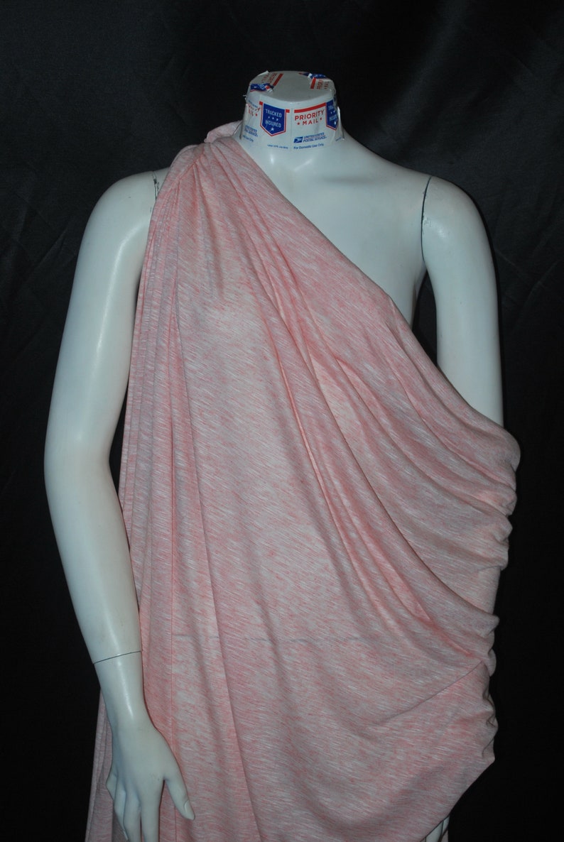 May include: A pink and white striped fabric draped over a white mannequin. The fabric is soft and flowing, and it has a subtle sheen.