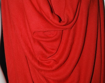 May include: Red ribbed knit fabric draped on a mannequin. The fabric is soft and has a slight sheen.