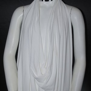 May include: White draped fabric with the word "HEF" printed on the neckline.