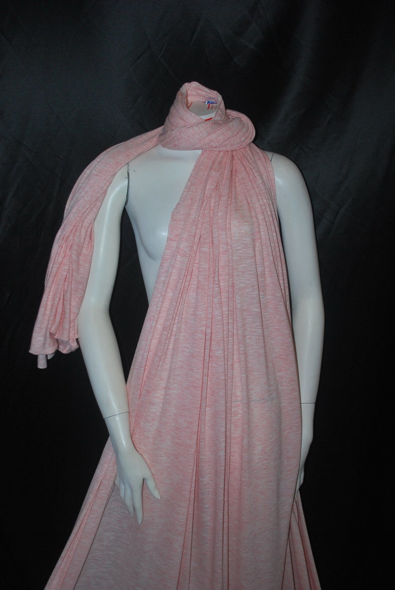May include: A pink and white striped scarf made of a soft, stretchy fabric. The scarf is draped over a mannequin.
