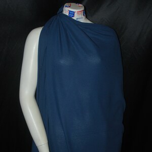 May include: A dark blue fabric draped over a mannequin. The fabric has a subtle ribbed texture.