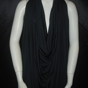 May include: A black draped top with a deep V-neckline. The top is made of a soft, stretchy fabric and has a relaxed fit.