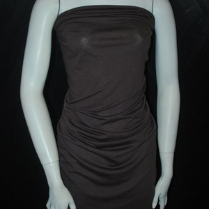 May include: A brown sleeveless dress with a gathered bodice and a fitted skirt.