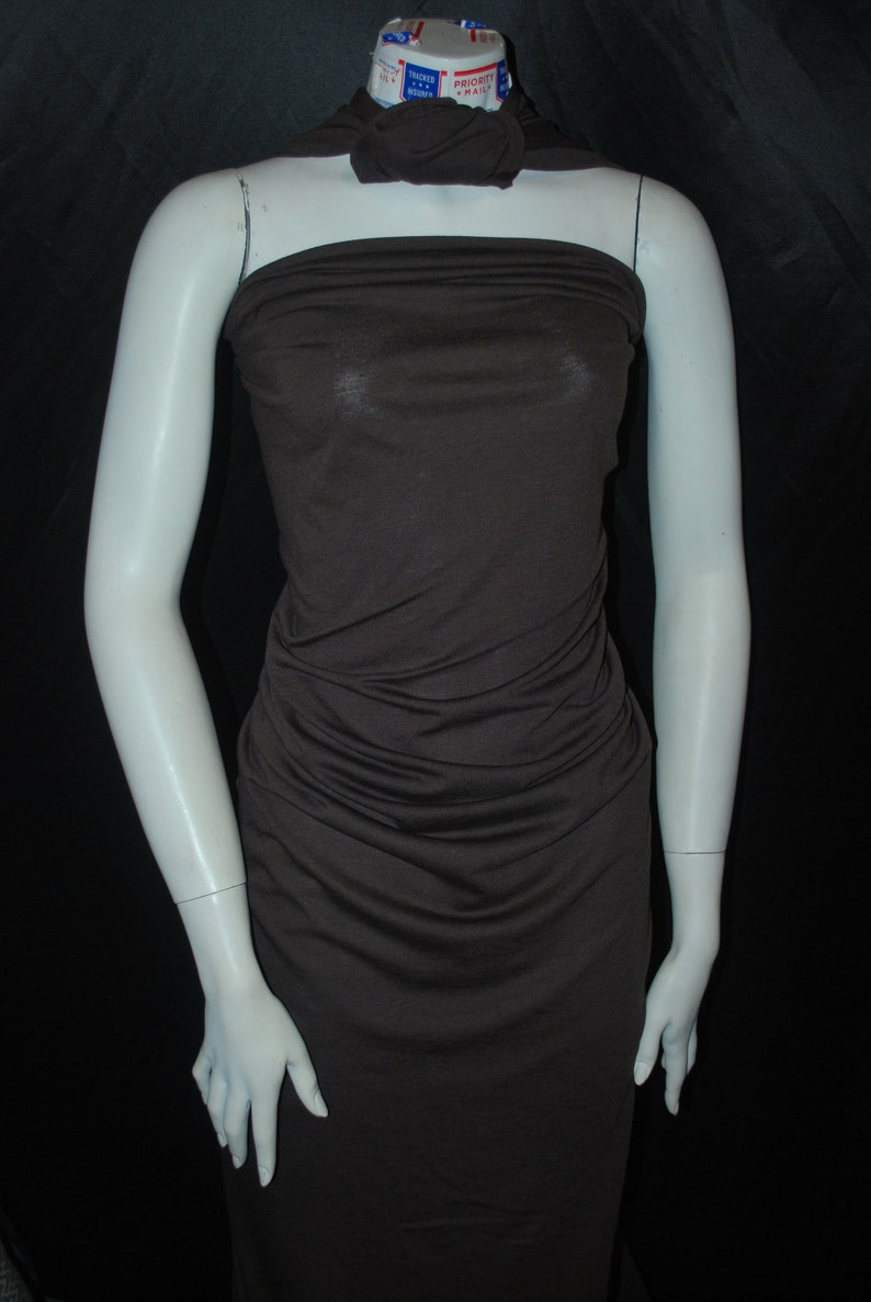 May include: A brown sleeveless dress with a gathered bodice and a fitted skirt.