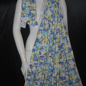 May include: A white, blue, and green floral print scarf. The scarf is made of a soft, lightweight fabric and is perfect for adding a touch of color to any outfit.