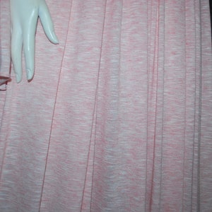 May include: A pink and white striped fabric with a subtle texture. The fabric is pleated and has a soft, flowing appearance.
