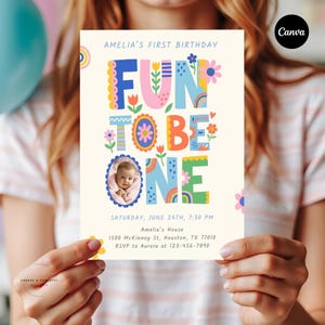 Fun To Be One Photo Invite Girl editable template featuring a modern one is fun invite style, personalized baby photo invitation with drag and drop photo editing, colorful birthday details, and matching thank you tag included.
