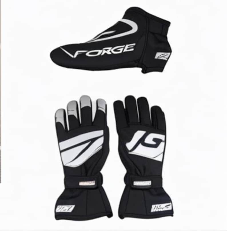 May include: Black racing gloves and shoe cover set. The shoe cover has the word "FORGE" in white. The gloves have white accents and a wrist strap. The gloves and shoe cover are designed for racing.