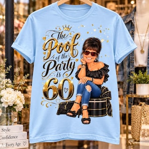 May include: A light blue t-shirt featuring a graphic of a person wearing sunglasses, a black off-the-shoulder top, and blue jeans, sitting on a gift box. The text reads, "The Poof of the Party is 60," with gold glitter accents and a crown.