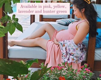 May include: A woman wearing a pink maxi dress with a floral print overlay. The dress has a pocket on the front. The text "Still living in the Mellow Rose pocket dress. Selling for $83, DM to order. Available in pink, yellow, lavender and hunter green" is superimposed on the image.