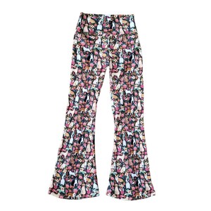 May include: Black flared pants with a colorful print of dogs and flowers.