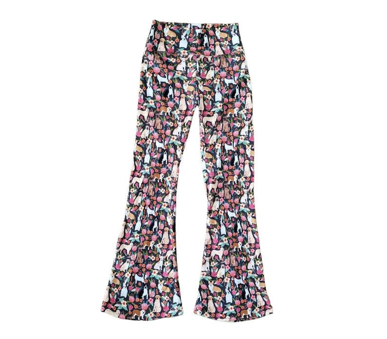 May include: Black flared pants with a colorful print of dogs and flowers.