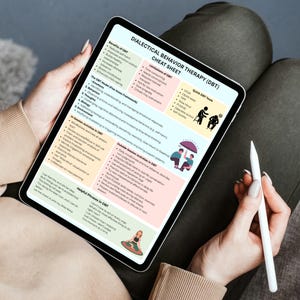 May include: A tablet displaying a "Dialectical Behavior Therapy (DBT) Cheat Sheet." The screen shows text and graphics outlining DBT concepts, including benefits, limitations, and helpful phrases. A white stylus rests beside the tablet. The tablet is held on a person's lap.