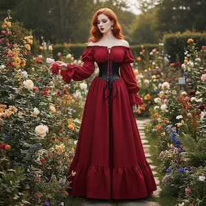 May include: A burgundy off-the-shoulder dress with long sleeves and a black corset. The dress features a full skirt with a ruffled hem. The woman is standing in a garden with colorful flowers.