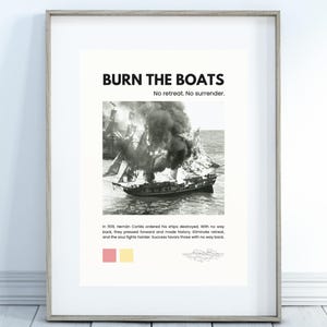 May include: Framed print with the text "BURN THE BOATS" and "No retreat. No surrender." A black and white image of a ship on fire is below the text. The print also includes a quote about Hernán Cortés.