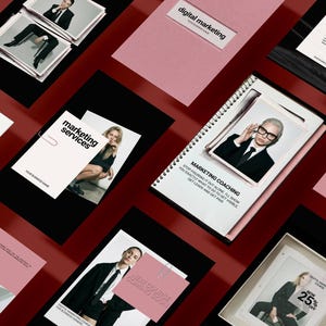 May include: A flat lay of marketing materials on a red background. The items include pink and black cards, a spiral-bound notebook, and photographs of people in business attire. Text includes "digital marketing" and "marketing services".