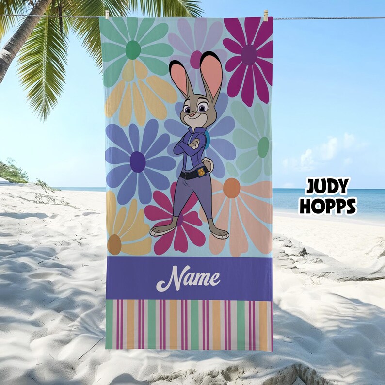 May include: A beach towel featuring Judy Hopps from Zootopia, with a floral background in pastel colors. The towel has a purple stripe at the bottom with the word "Name" and striped accents. The text "JUDY HOPPS" is on the right side.