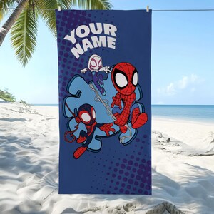 May include: A blue beach towel featuring cartoon Spider-Man characters. The towel has a large graphic of Spider-Man, Spider-Gwen, and Miles Morales. The text "YOUR NAME" is at the top. The background has a blue puzzle piece shape and a dotted pattern.