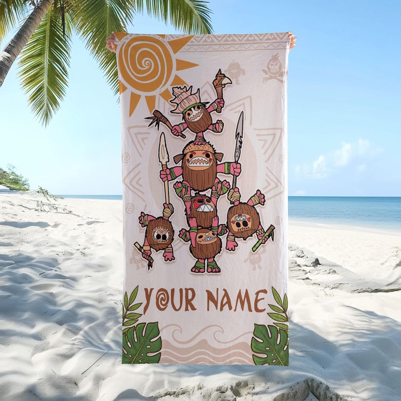 May include: A beach towel featuring a cartoon illustration of several coconut-like characters stacked on top of each other, holding spears and weapons. The towel has a light beige background with a sun and tribal patterns. The text "YOUR NAME" is printed at the bottom.