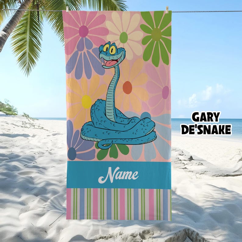 May include: A beach towel featuring a cartoon snake character in shades of blue, set against a backdrop of large, colorful flowers. The towel has a blue stripe with the word "Name" and a striped border. The text "GARY DE'SNAKE" is also visible.