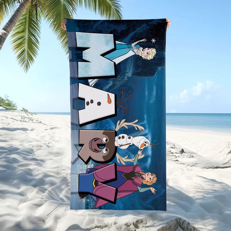 May include: A rectangular beach towel featuring a dark blue background with the name MARY spelled out in large, block-style letters. The design incorporates characters from the movie Frozen, including Elsa, Anna, Olaf the snowman, and Sven the reindeer.