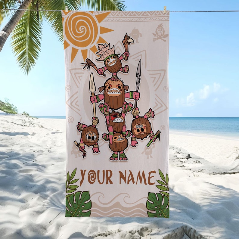 May include: A beige beach towel featuring a cartoon illustration of coconut characters in a pyramid formation, holding spears and weapons. The towel includes the text "YOUR NAME" in brown, with a sun and tropical leaf design. The towel is hanging on a clothesline on a beach.