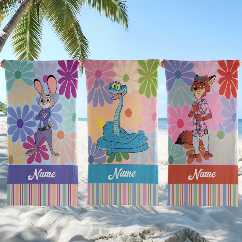 May include: Three beach towels featuring cartoon characters and floral backgrounds. Each towel has a different character: a rabbit, a snake, and a fox. The towels have a striped bottom section with the word "Name" printed on them.