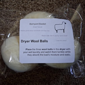 May include: A package of three dryer wool balls. The label reads "Dryer Wool Balls" and includes instructions for use. The packaging also includes the text "Barnyard Basket" and "Made with 100% family farm wool!"