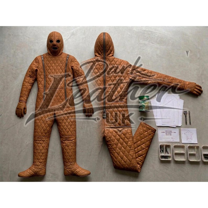 May include: Two brown quilted full-body suits with zippers, one with a hood and the other with a mask. The suits are displayed on a light gray surface, along with sewing supplies and a can of green paint.