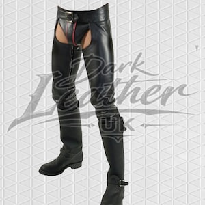 May include: Black leather chaps with a red zip and buckle fastenings. The chaps have a cutout design and are worn with black boots. The image is set against a white geometric background.