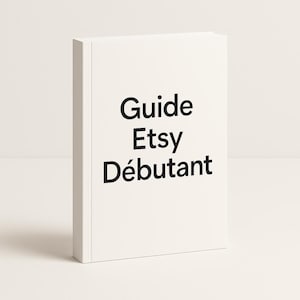 May include: A white book with the title "Guide Etsy Débutant" in black text. The book is standing upright, with the spine facing the viewer. The cover is plain white, and the text is centered.
