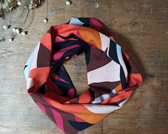 Geometric color block printed tube snood scarf in orange/pink/black tones