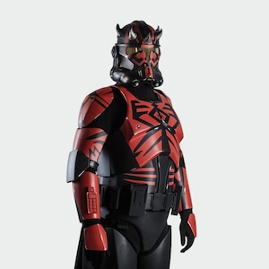 May include: A red and black costume with a helmet and body armour. The helmet has horns and a visor, and the armour features geometric patterns. The costume is likely inspired by a science fiction theme, with a striking and detailed design.
