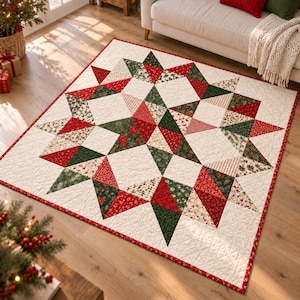 May include: A square patchwork quilt featuring a large central star pattern composed of red, dark green, and cream fabric triangles. The quilt has a cream background with intricate floral and geometric prints and a thin red border.