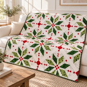 May include: A quilted throw blanket featuring a repeating star pattern in shades of forest green and lime green, accented with small red squares and white fabric sections. The quilt has visible stitching lines and a white border trim.