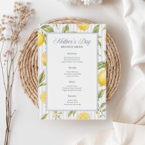 May include: A Mother's Day brunch menu card featuring a lemon and leaf watercolour design. The menu, with the text "Mother's Day Brunch Menu", is set against a white and light blue striped backdrop. It lists starters, drinks, main courses, and sweets.