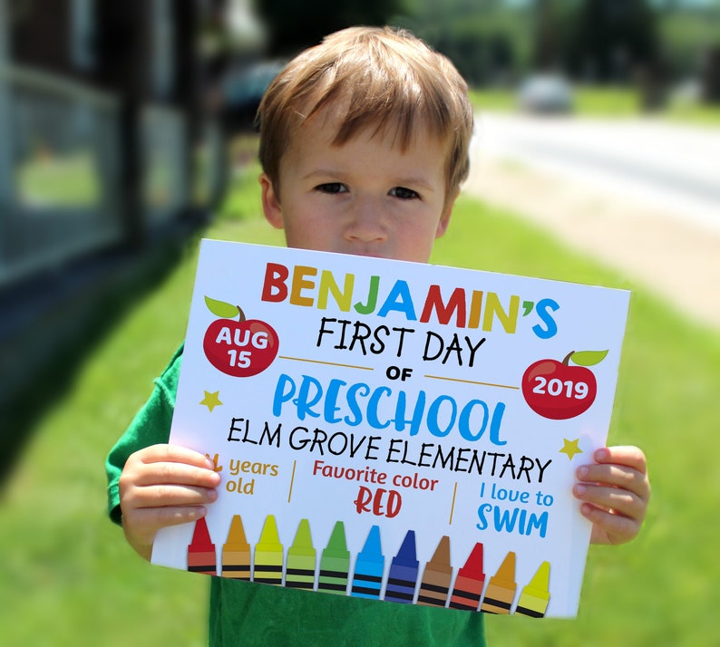 child holding Editable First day of school sign personalized school sign