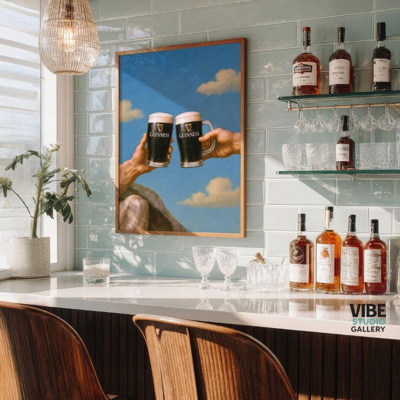 May include: A framed print depicts two hands toasting with Guinness beer mugs against a blue sky with clouds. The print is displayed above a bar with various bottles of liquor and glassware. The bar has a light-colored countertop and wooden chairs.