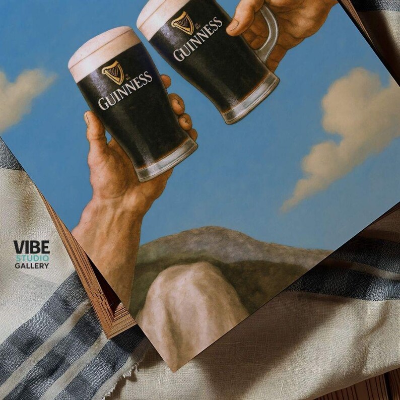 May include: A print featuring two hands holding up two pints of Guinness. The pints are filled with dark stout and topped with a creamy white head. The Guinness logo is visible on the glasses. The background is a blue sky with a cloud.