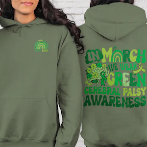Op de afbeelding: Olijfgroene hoodie met een regenboogontwerp op de borst en de tekst "Cerebral Palsy Alex". De achterkant van de hoodie heeft de tekst "In March We Wear Green Cerebral Palsy Awareness" met een hersengrafiek en een lint.