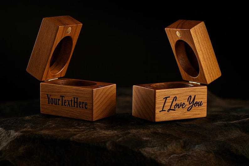 May include: Two open wooden ring boxes with a hinged lid and a circular opening. One box has "YourTextHere" engraved, the other says "I Love You". The boxes are made of light brown wood.