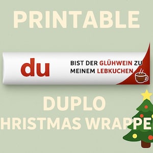 Könnte beinhalten: Ein druckbares Weihnachtsverpackungsdesign mit dem roten Wort "du". Der Text auf der Verpackung lautet "BIST DER GLÜHWEIN ZU MEINEM LEBKUCHEN" mit einer Kaffeetassengrafik. Die Wörter "DUPLO" und "CHRISTMAS WRAPPER" sind ebenfalls sichtbar.