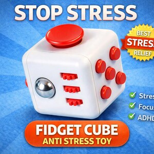 Könnte beinhalten: Weißer Fidget Cube mit roten Knöpfen und einer silbernen Kugel, mit der Aufschrift "STOP STRESS" und "FIDGET CUBE ANTI STRESS TOY". Das Bild enthält auch Text, der Stressabbau, Konzentrationshilfe und ADHS-freundliche Eigenschaften anzeigt.