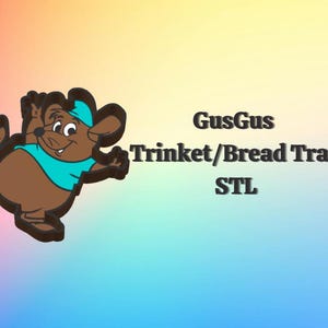 May include: A cartoon illustration of GusGus, a brown mouse character, wearing a blue hat and shirt, with the text "GusGus Trinket/Bread Tray STL" on a colorful gradient background.
