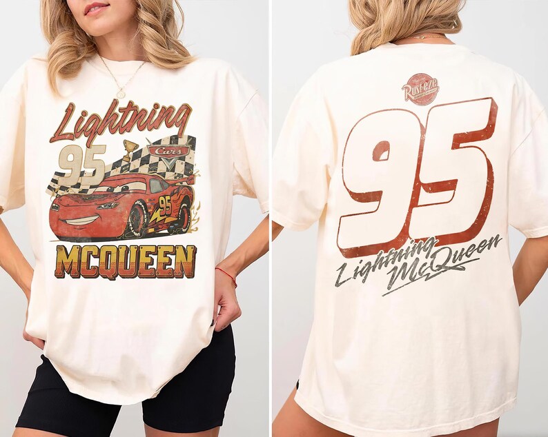 May include: An off-white t-shirt featuring a graphic of Lightning McQueen with the text Lightning 95 McQueen on the front and a large number 95 with the text Lightning McQueen and a Rust-eze logo on the back.