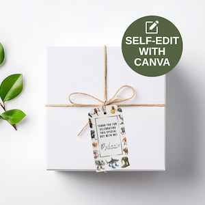 May include: A white gift box tied with twine, featuring a decorative tag with various illustrations and the text "Thank you for celebrating this special day with me!" and "Dylan's". A green leaf branch is on the left.
