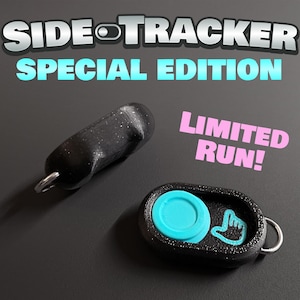 May include: Two black Side-Tracker Special Edition fidget devices with a metallic ring attachment. One device is oval-shaped with a bright turquoise circular button and a turquoise hand icon. The text reads SIDE-TRACKER SPECIAL EDITION LIMITED RUN!
