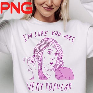 Könnte beinhalten: Weißes Sweatshirt mit einer lila Grafik einer überraschten Frau und dem Text "I'M SURE YOU ARE VERY POPULAR". Die Illustration ist im Strichstil gehalten.