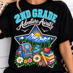 May include: A black t-shirt featuring a graphic of a star containing a mountain landscape, a blue backpack, a compass, a yellow pencil, a red apple, and a stack of books. The text reads 2ND GRADE Adventure Awaits in blue and white lettering.